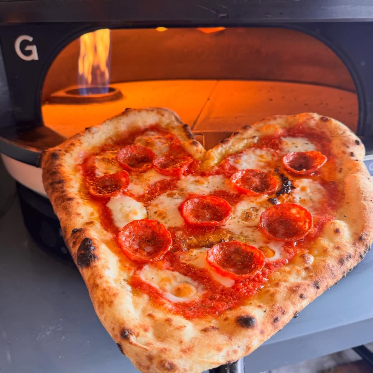 Heart-shaped pepperoni pizza from Gozney oven, perfect for weddings