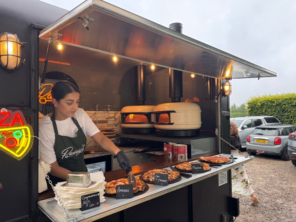 Fresh artisan pizzas served at outdoor celebration